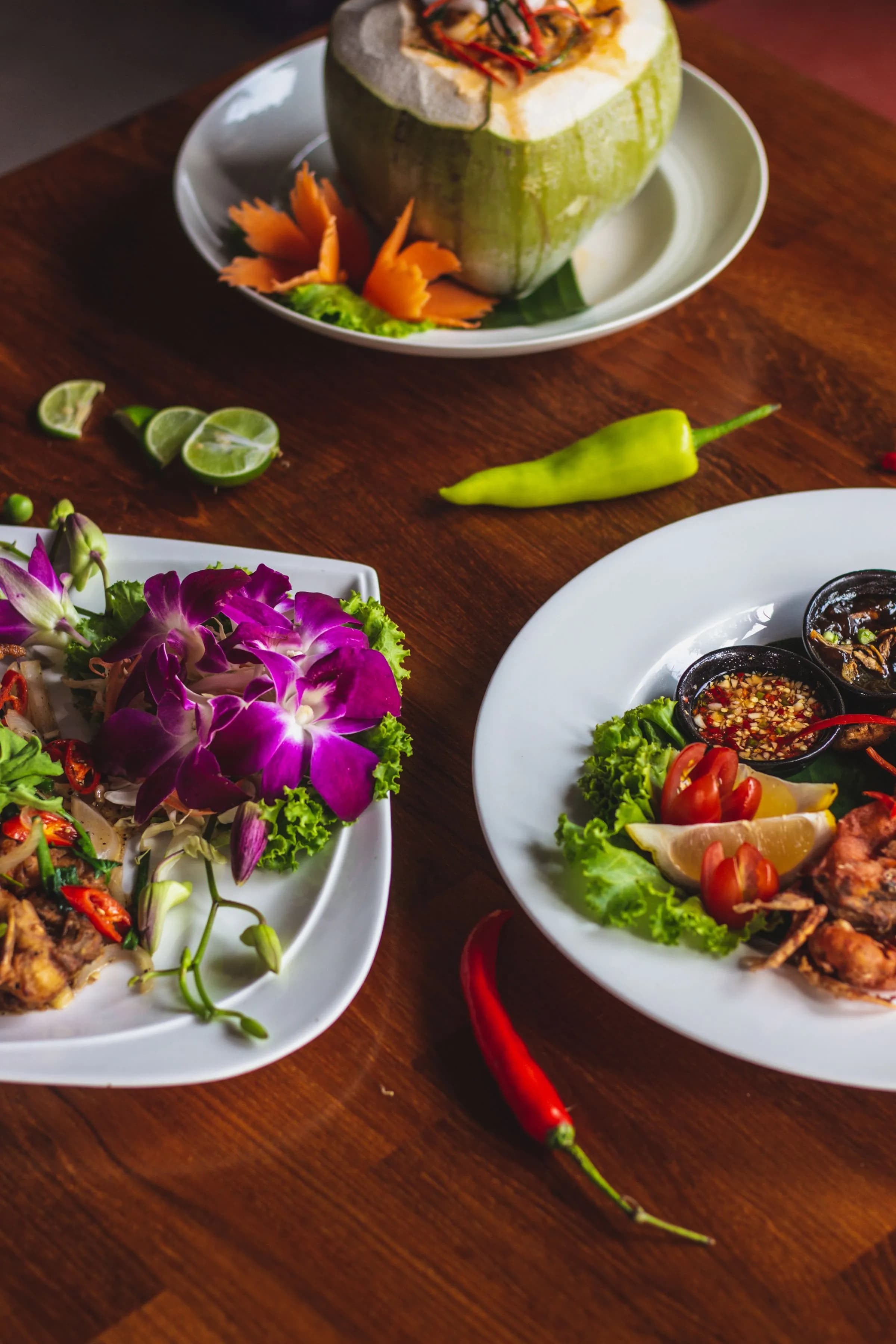 Thai dishes with orchids and fresh herbs