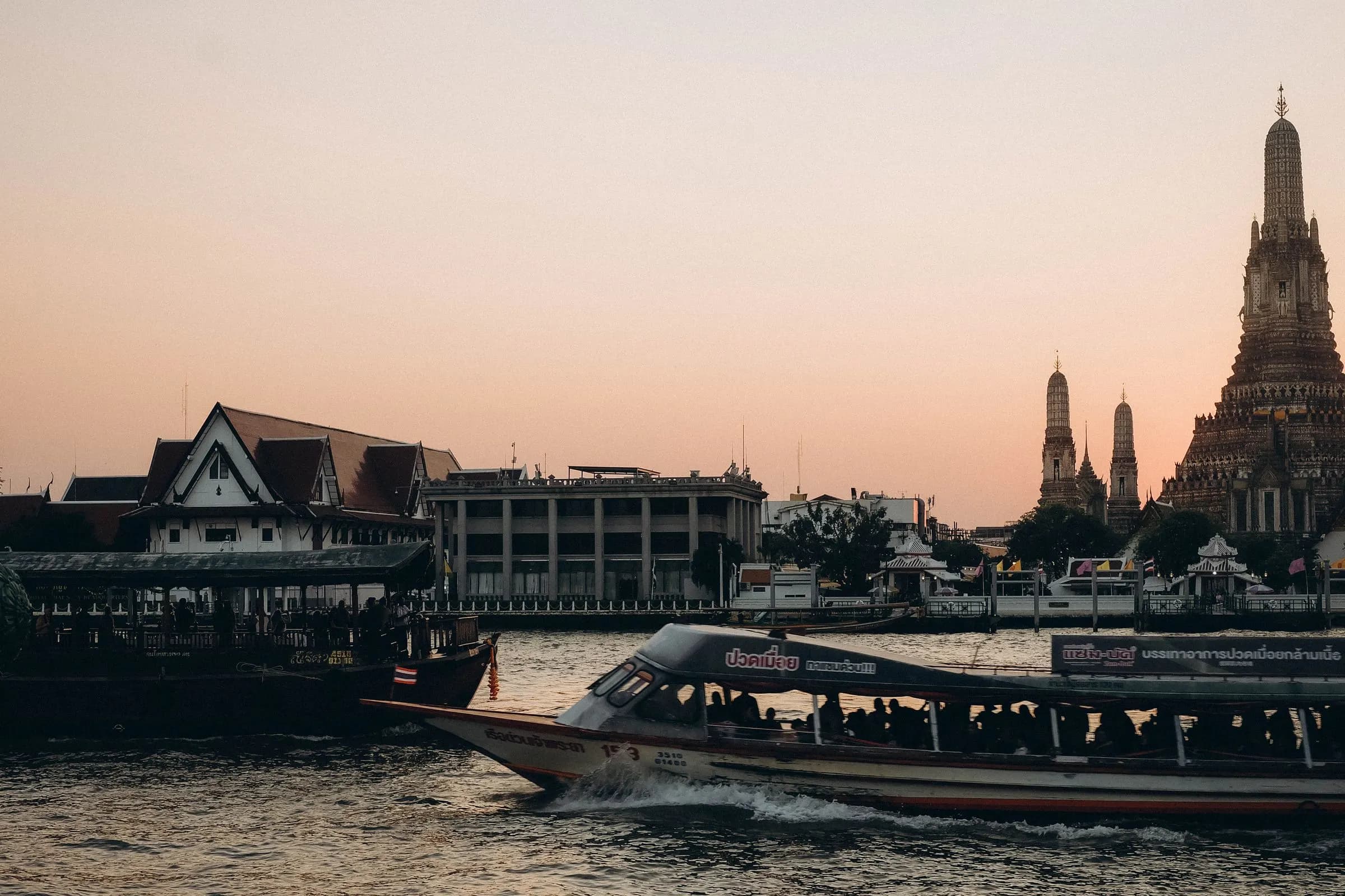 Wat Arun and a river boat at sunset