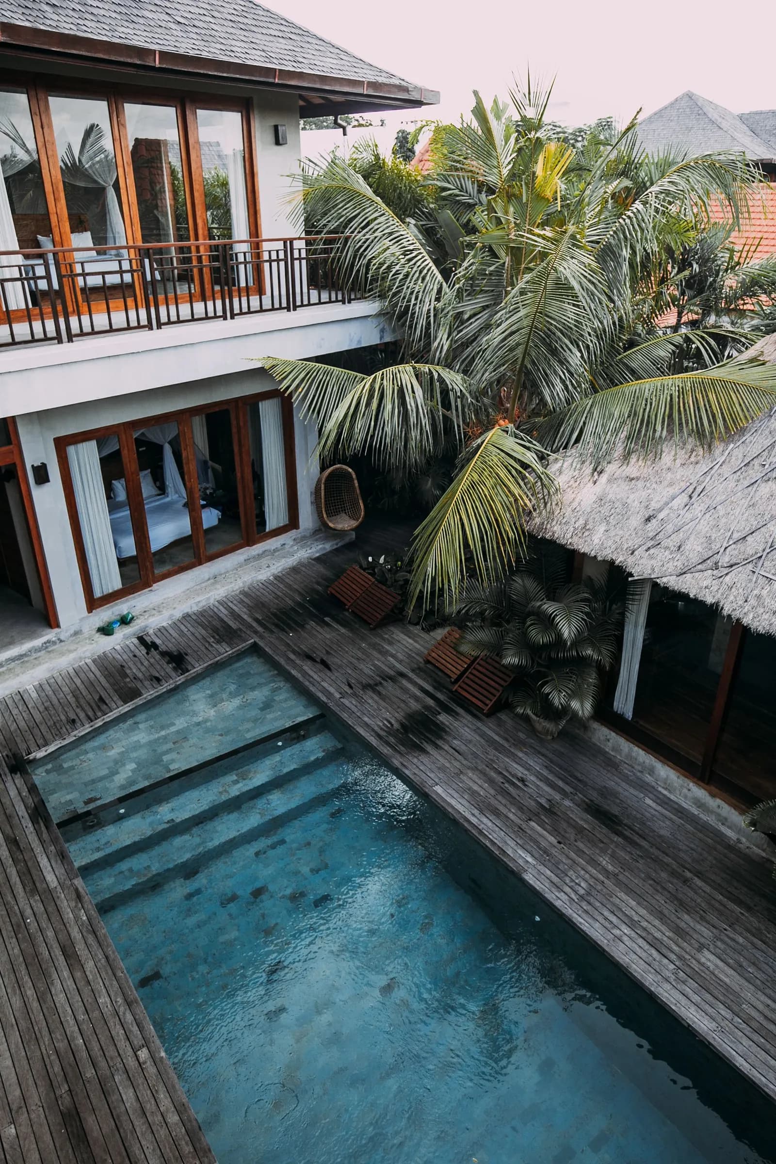 Aerial view of a wooden villa with a private pool