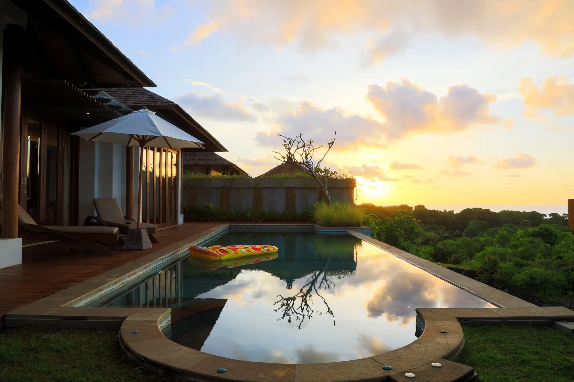 Villa pool reflecting the sunset