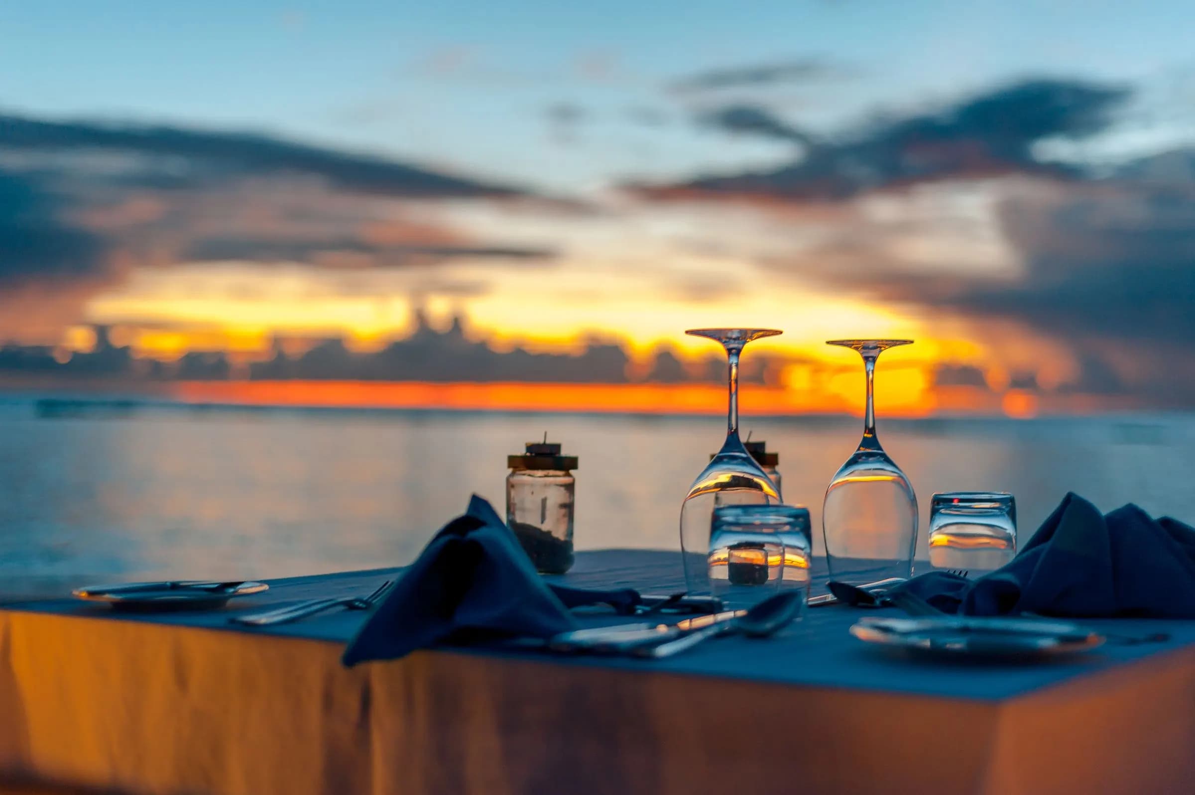 Table set by the sea at sunset