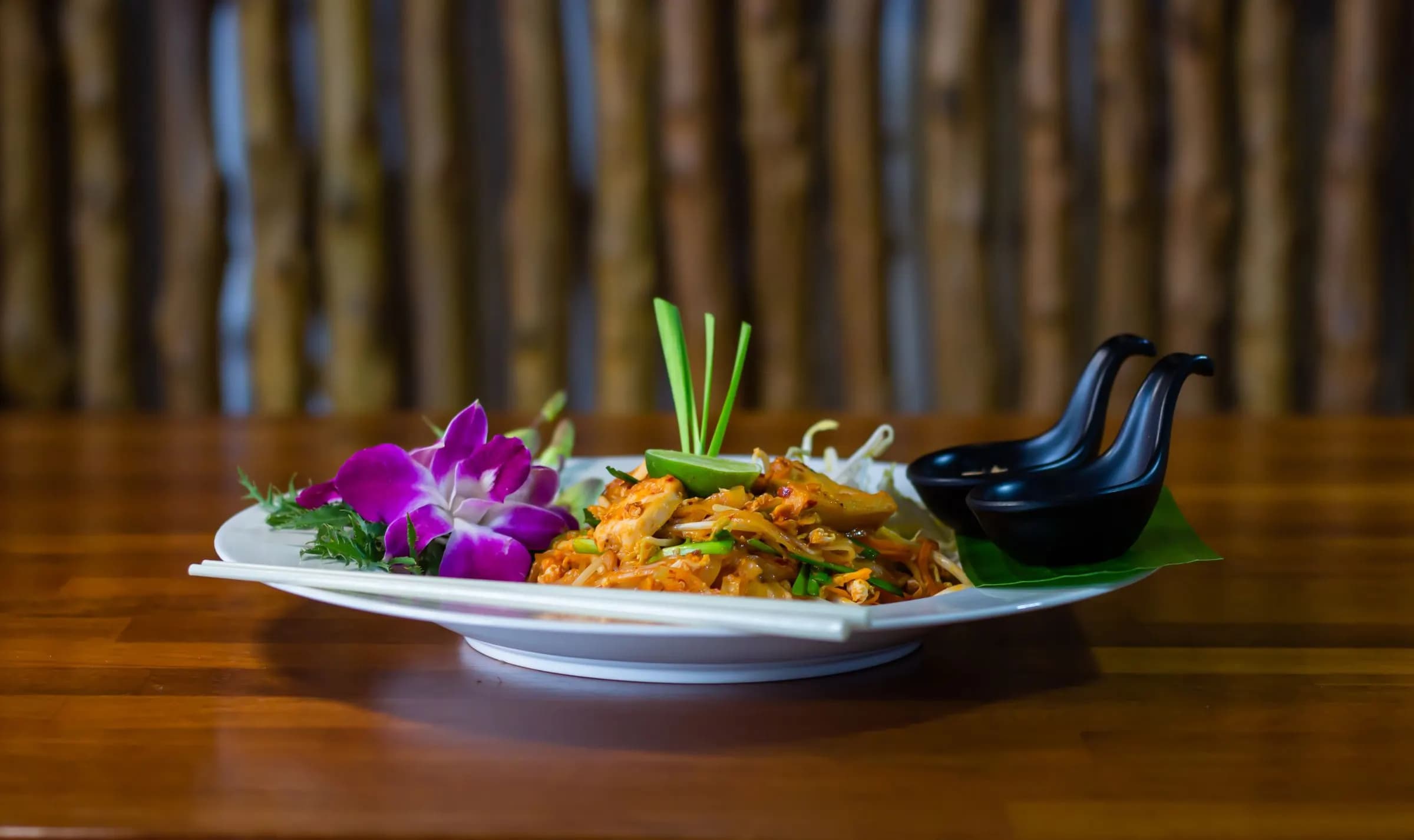 Thai dish plated with an orchid