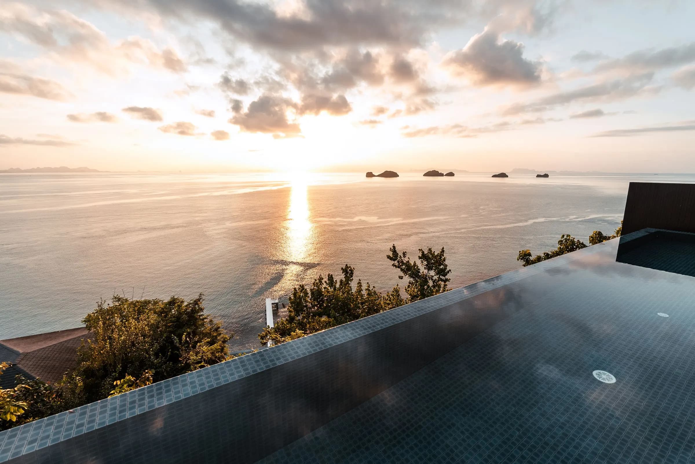 Infinity pool facing the sea at sunset