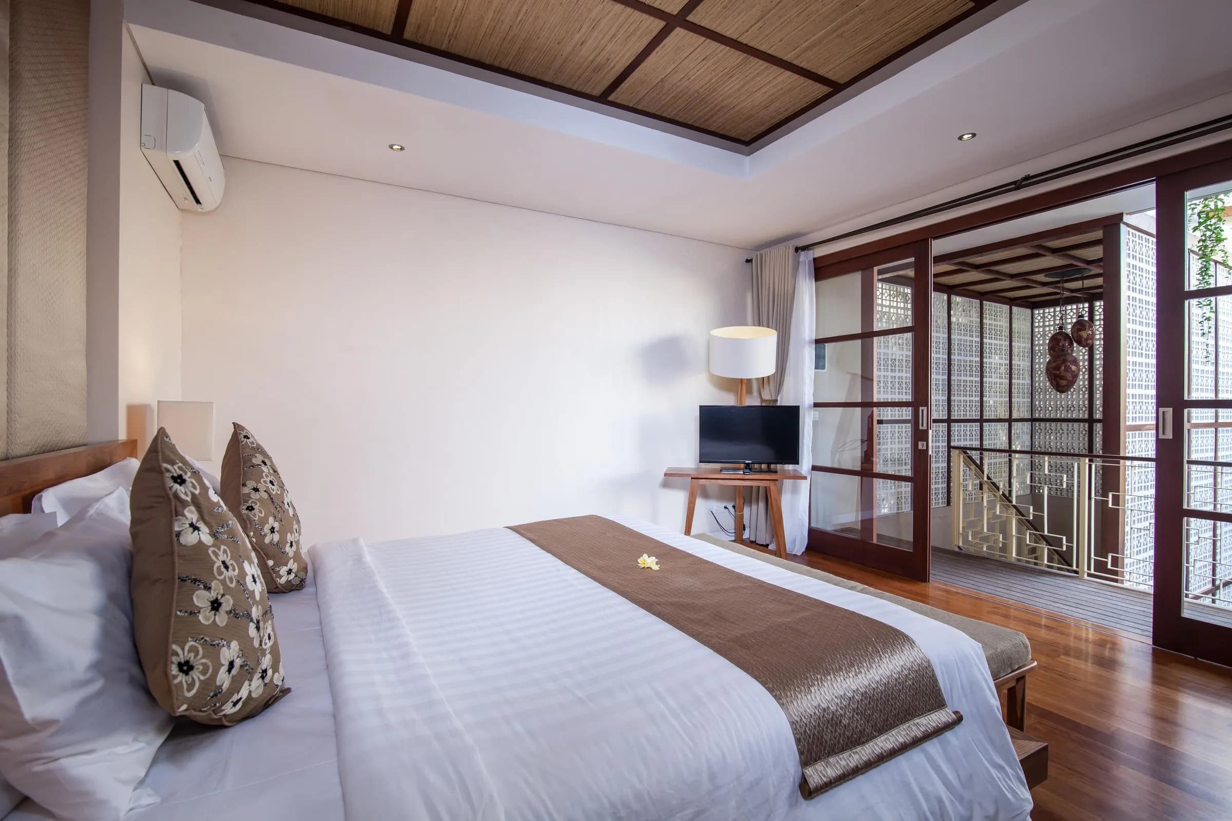 Bedroom with timber floors and white linen