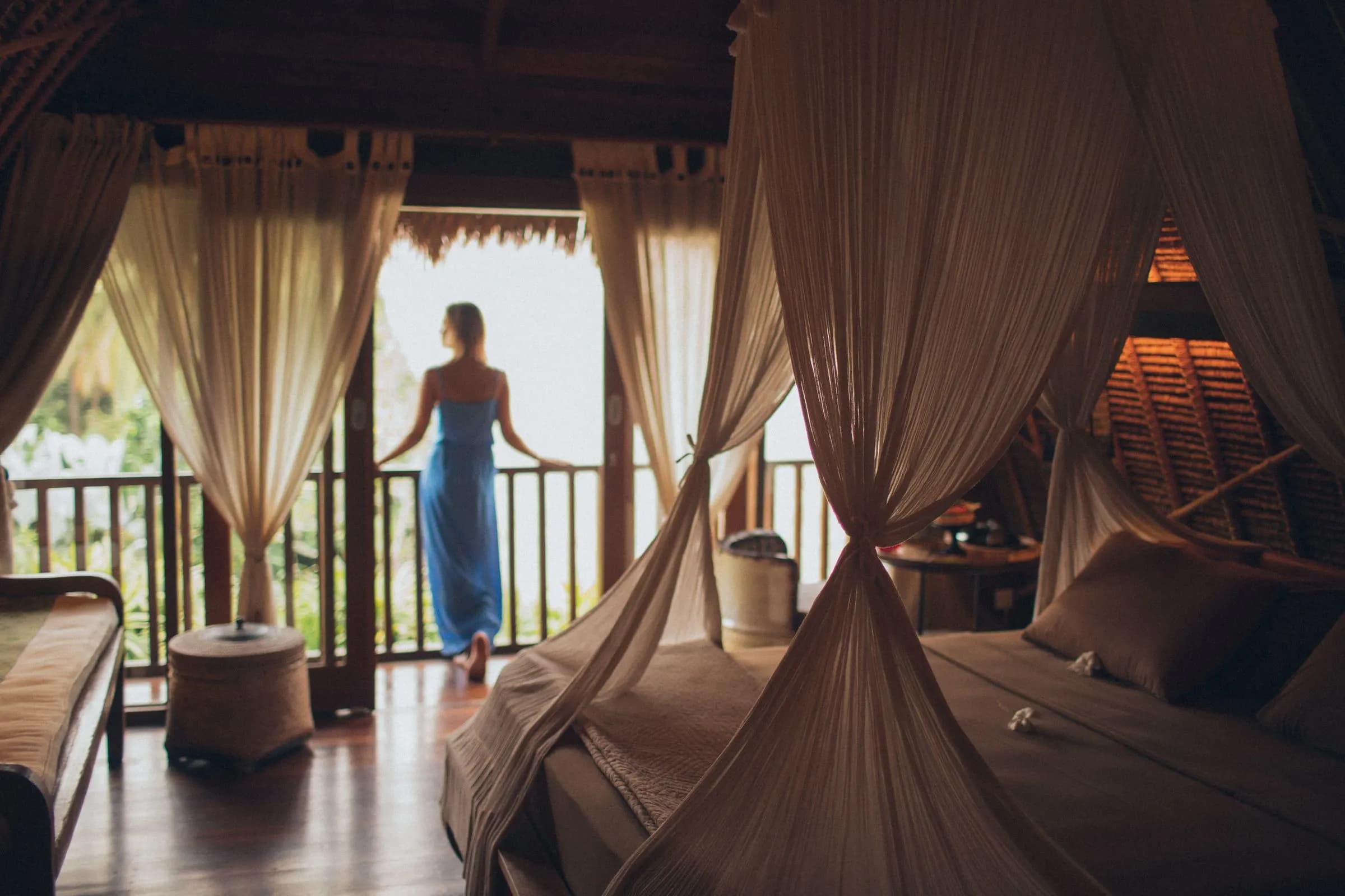 Suite with a canopy bed and a balcony over the trees